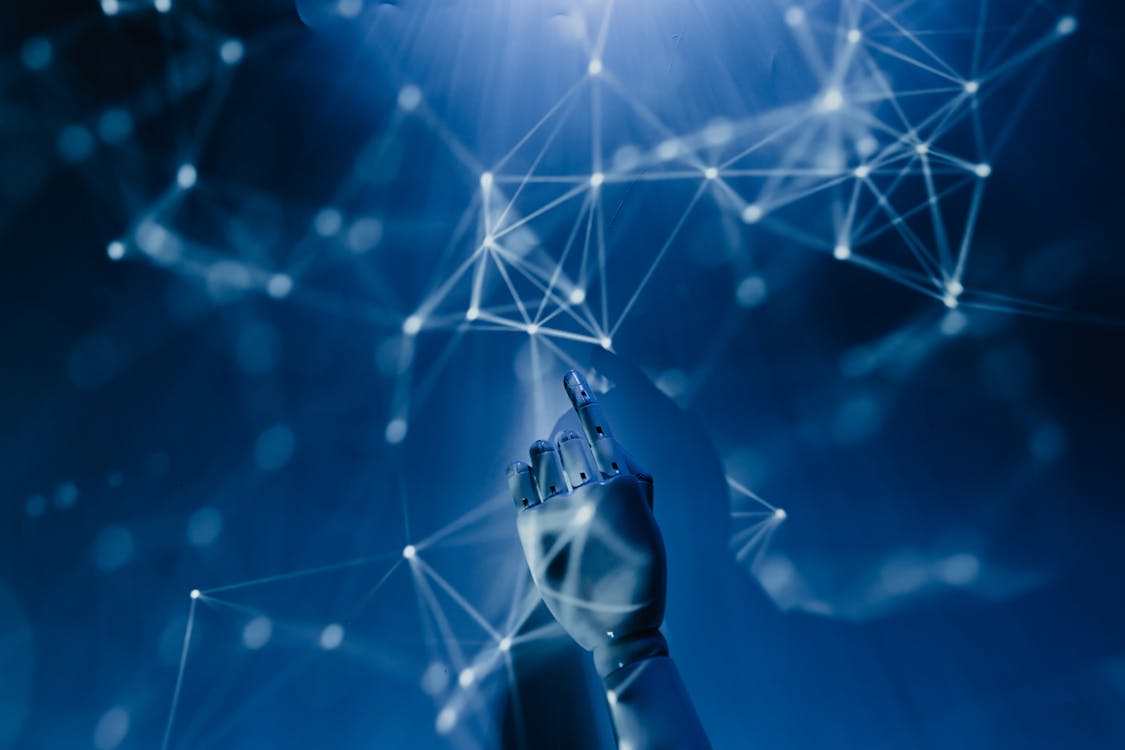 AI robot hand reaching into digital network
