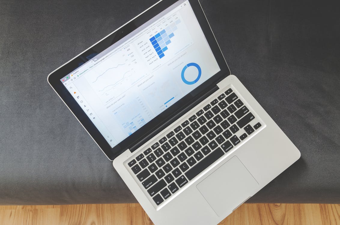 Laptop displaying analytics dashboard with charts and data